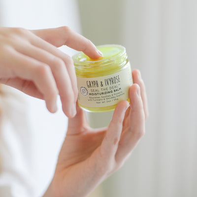 Seal the Deal moisturizing balm with turmeric and young girls hand